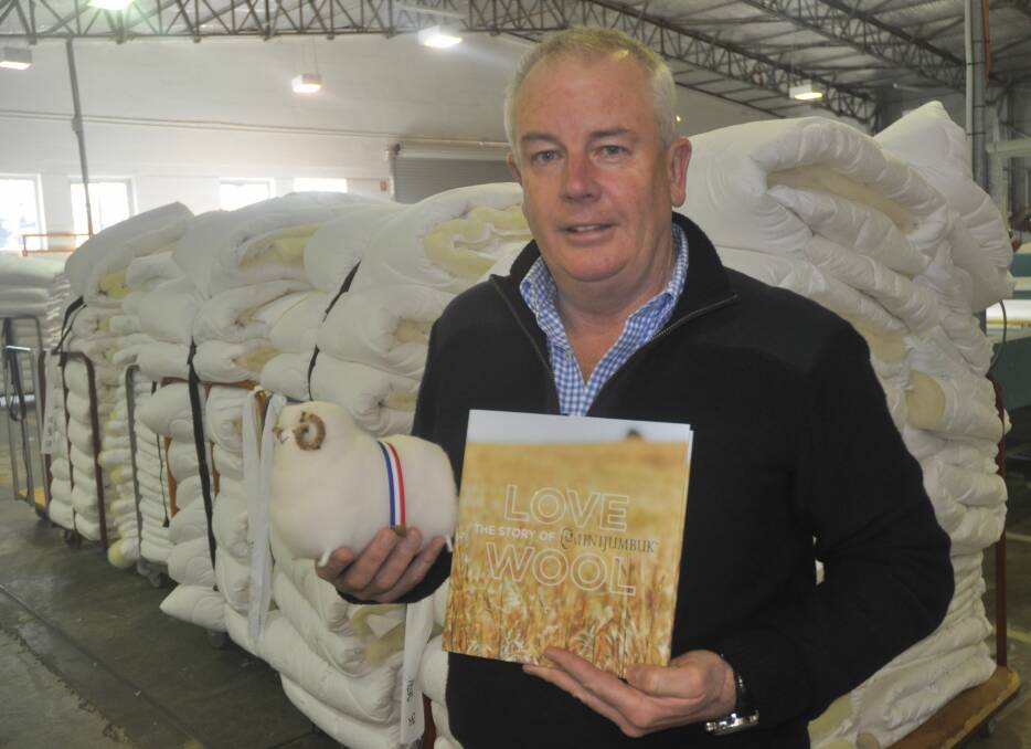 LOVE WOOL: MiniJumbuk managing director Darren Turner with the company's first product - a handcrafted souvenir sheep and the 200-page Love Wool book launched last month for the 40th anniversary.