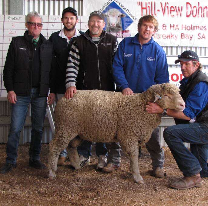 STUD BUY: Landmark's Peter McEvoy and top price ram buyer Paul Webb, Eagle Ridge, Cowell (third from left) with Robert, Milton and Peter Holmes, Hill-View stud.