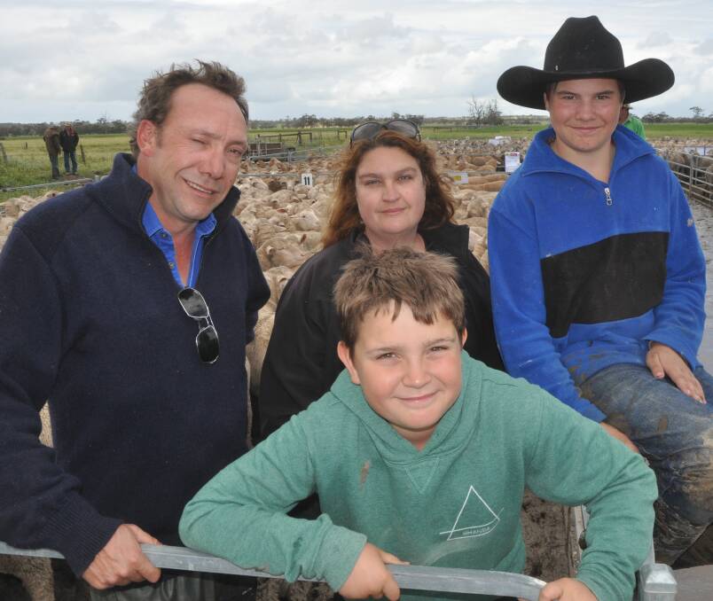FAMILY TIME: Haydn, Lachie and Poppy Lines, Lines Family Partnership, Keith, with Jack Batson, sold 608 1.5-year-old Gum Hill-blood ewes to $254, av $230.55.