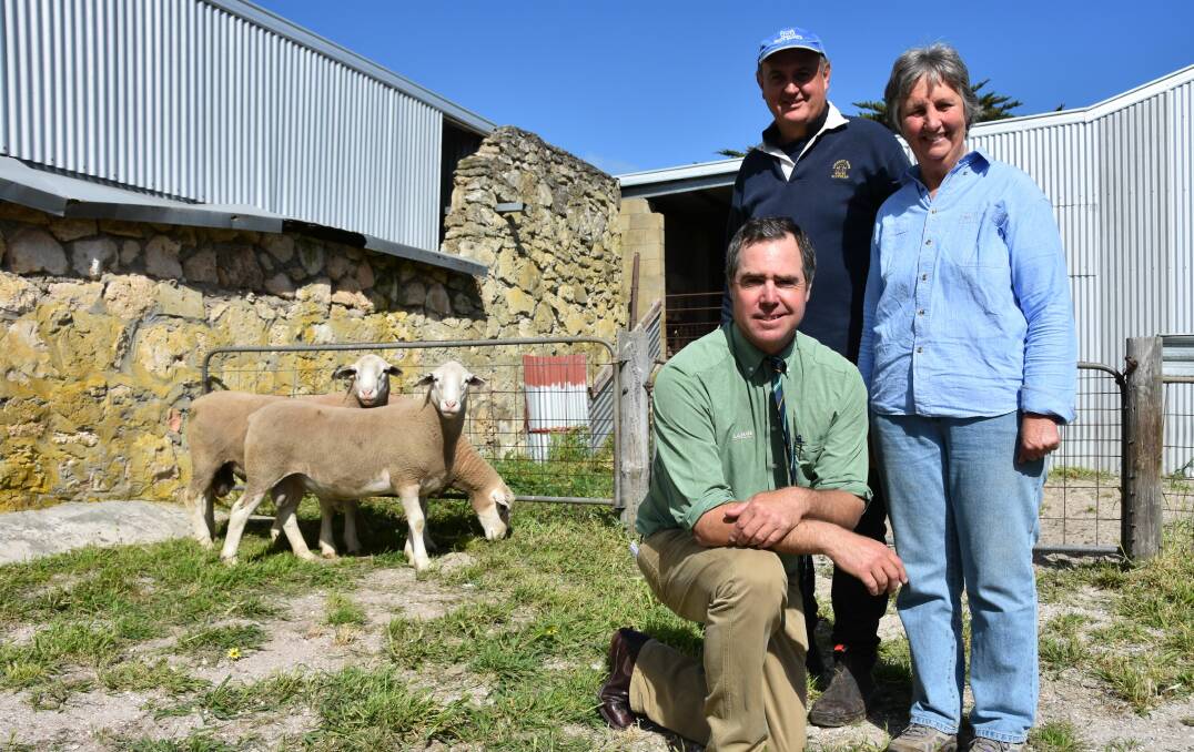 NEW RECORD: Landmark auctioneer Richard Miller (kneeling) with Ian Cass, Loxton, who bought the $4600 top price ram for Rhogwyn stud, WA, and Richmond Park stud principal Mary Burzacott.