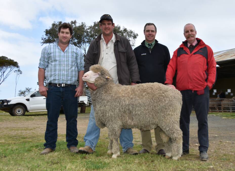 Matt Lehmann, Flairdale, Cookes Plains, with the $5400 equal top priced ram being held by Fred Laskey, Orroroo with auctioneers Landmark's Richard Miller and Elders' Tom Penna.