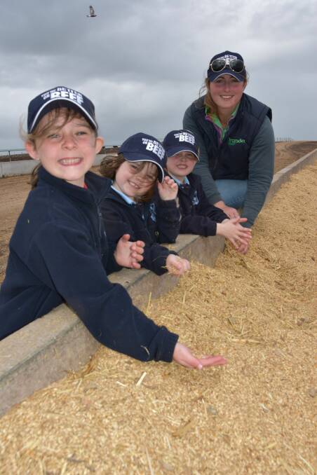 Tintinara Area School Foundation year students Taylor Schilling, Pippa Nankivell and Stella Richardson check out a feed bunker with Iranda Beef's Shay Pratt 