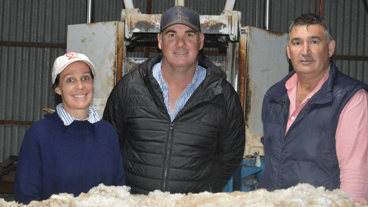 FLEECE INSPECTION: Hamilton Run stud principals Nicole Luckraft and Greg Andrews, Jamestown, with Elders southern livestock sales manager Laryn Gogel inspect some of the ewes fleeces.