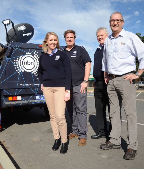 Long-awaited upgrade: NBN Co's Laura Murphy and Tim Saul, Regional Development Australia's Darryl Webb and Grain Growers' David Evans check out the Sky Muster service. Photo: Peri Strathearn.