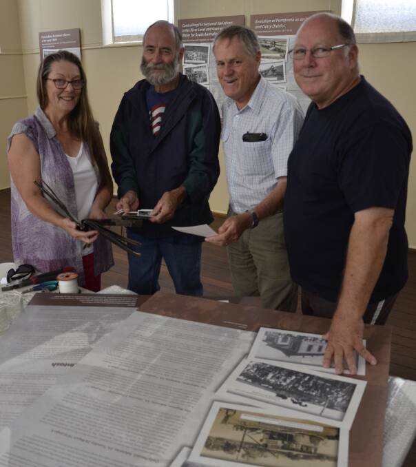 ON DISPLAY: Pompoota Community Hall Committee members Carolynn Sellick, Peter Sellick, Trevor Twigden and Graeme Buchan setting up an exhibition in the hall.
