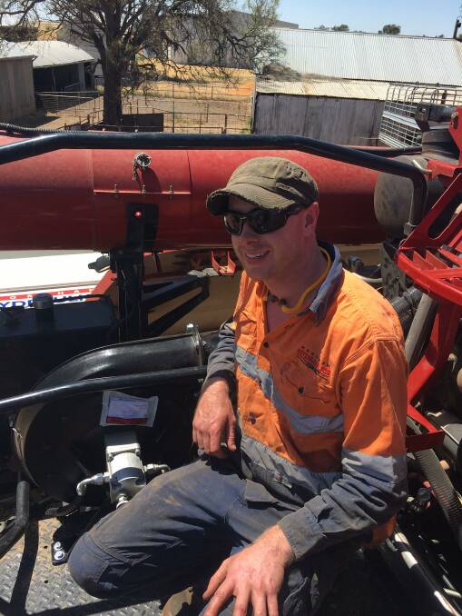 Horsham Hydraulics technician Nat Cooke fits the hydraulically operated fan system designed to keep dust from building up on harvester hot spots to David and Cathie Weidemann's header at Burrum, near Rupanyup.PIC: CATHIE WEIDEMANN.