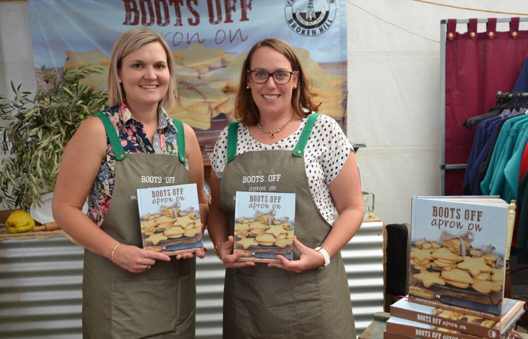 TASTE DELIGHT: Co-editor Bree Wakefield, Banoon Station, via Mildura, Vic, with Rebecca Pearce, Gumpoplar Station, via Broken Hill, NSW, and the new cookbook brought out to mark 60 years of the Broken Hill School of the Air.