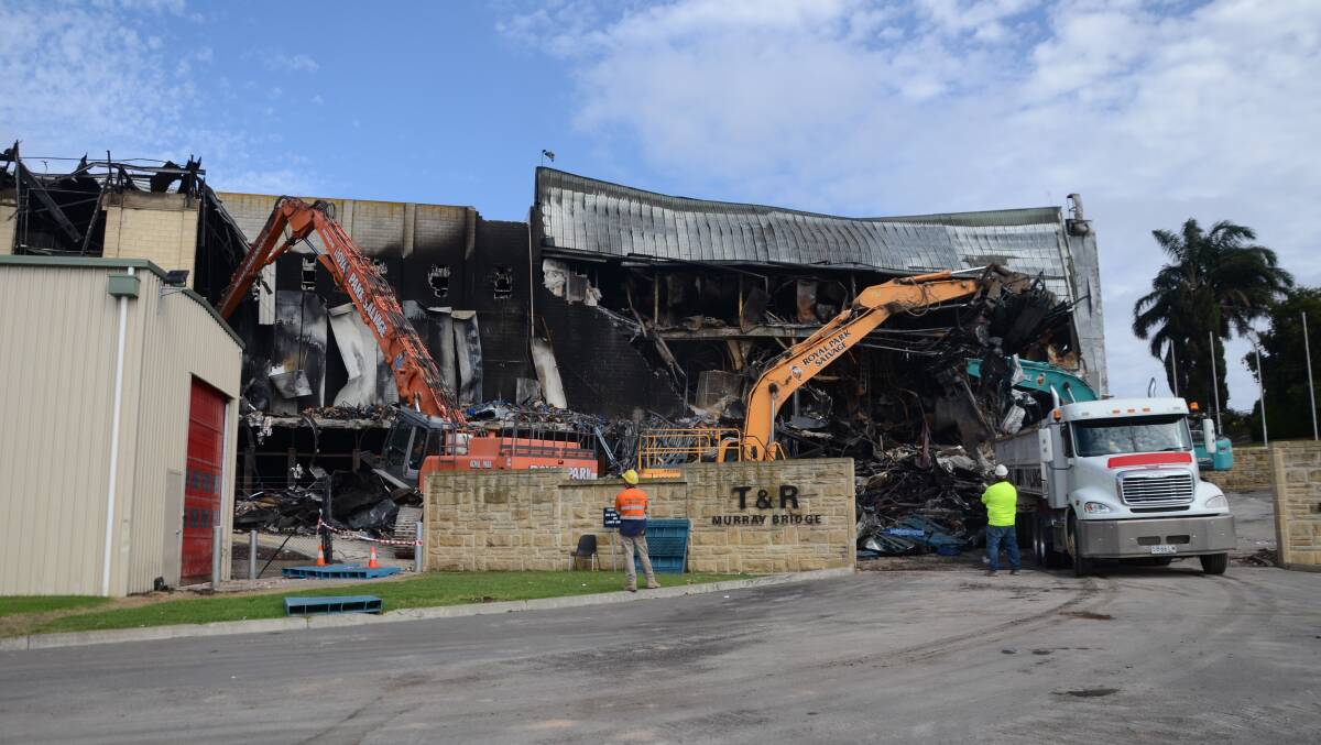 TIDY: Workers clear away wreckage at Thomas Foods International. Photo: Peri Strathearn. 