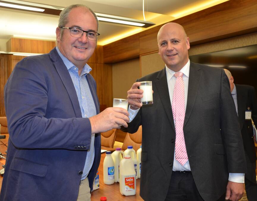 BOTTOMS UP: Agricultural Minister Leon Bignell and SA Dairyfarmers' Association president David Basham say consumers can do their bit to aid the industry by buying branded milk from SA producers.