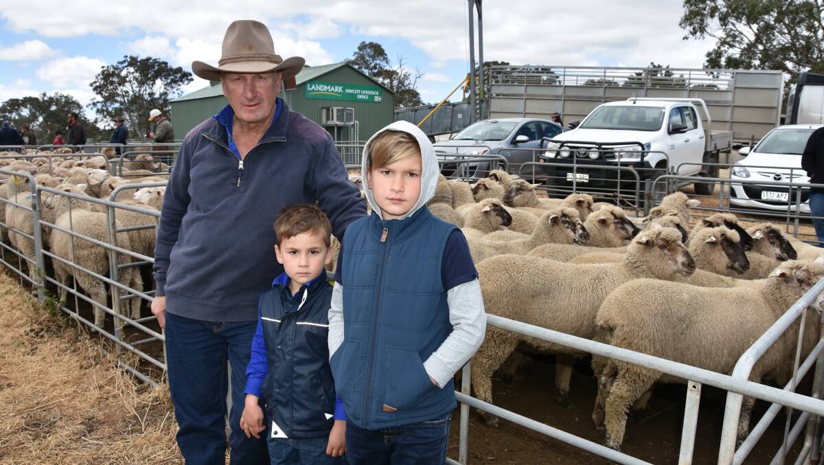 HAPPY VENDOR: Malcolm Mitchell, Eden Valley, with Toby and Blake Forshaw, Keyneton. Mr Mitchell was happy with his prices, with this pen of 26 lambs at $174.
