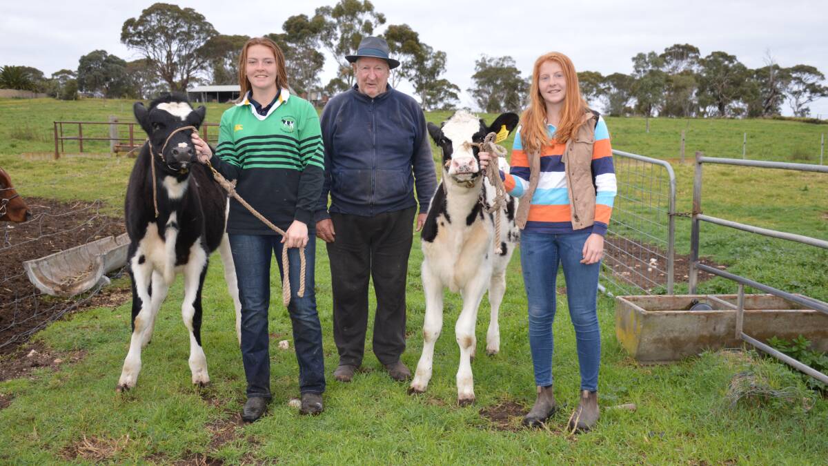 Courtney and Tegan Afford with grandfather Bob Afford (centre), Billabong Holsteins.