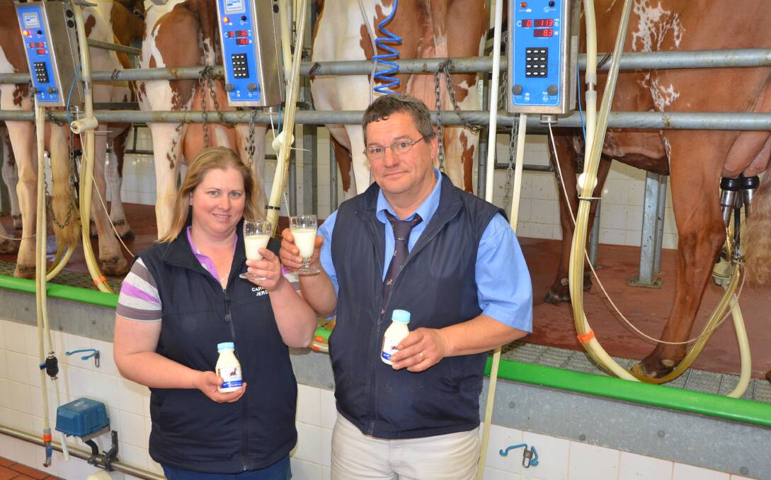 BOTTOMS UP: Jersey Fresh's Amy McDonald and Ayrshire breeder Greg Klatt with the Ayrshire branded milk.