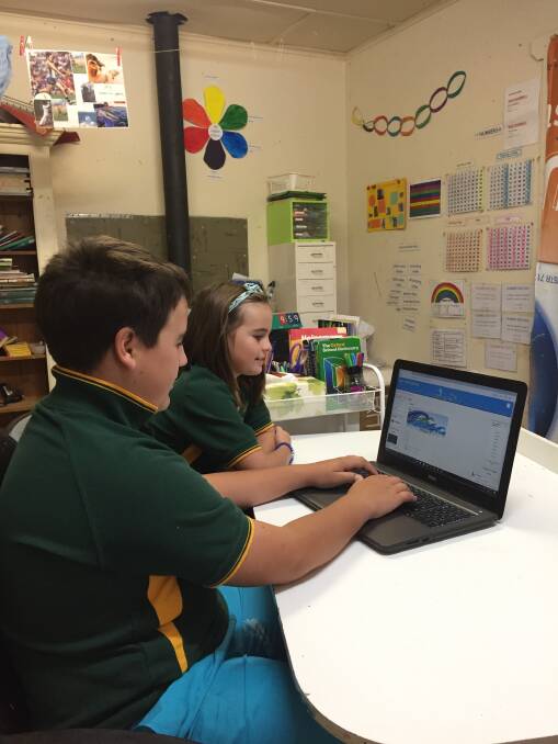 ONLINE LEARNING: Students Eddie, 12, and Lily, 7, Hatcher in their school room open Eddie's Moodle program to see lessons. Their mother Belinda Hatcher said the online components were a core part of their education, requiring good internet access.  