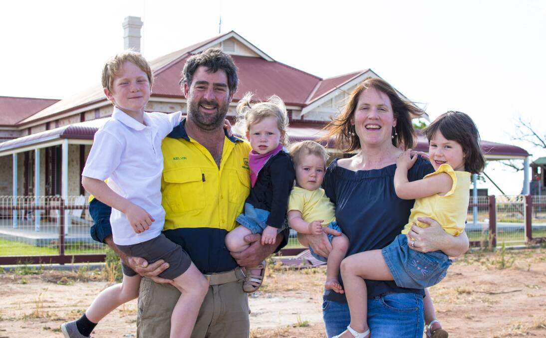 MOVING FORWARD: The Tiller family - Oscar, 6, Kelvin, Nellie, 2, Audrey, 10 months, Ali and Scarlett, 4 - in front of the original Tiller home. The family started farming in the area in the 1870s.