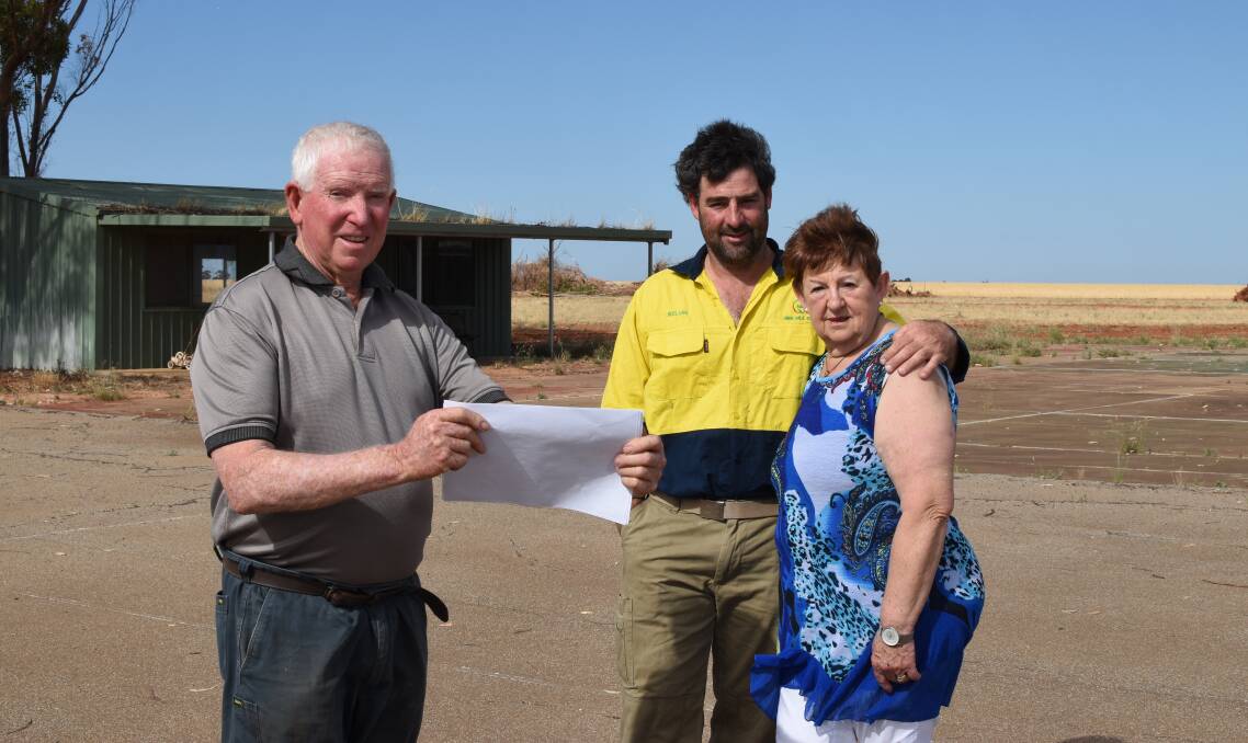 PLANS UNDERWAY: Grace Plains farmer Peter March shows Kelvin and Jenny Tiller the plans for the Pinery fire memorial site.