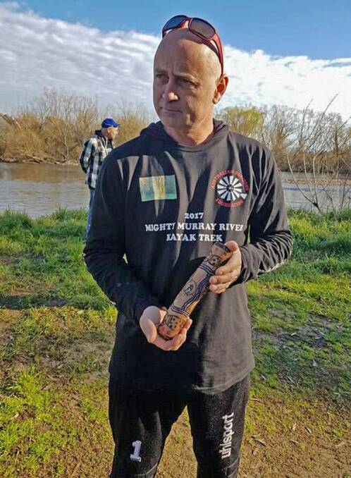 ON A MISSON: Kev Cook, Morgan, holds the message stick, given to him by the Wiradjuri Nation, as he paddles 2540 kilometres of the River Murray.
