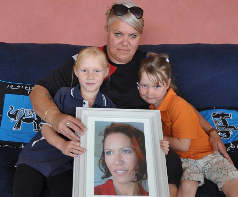 REMEMBERED: Bella Francis Suzanne Scanlon and Marley Francis with a photograph of their mum and sister Malinda Francis.