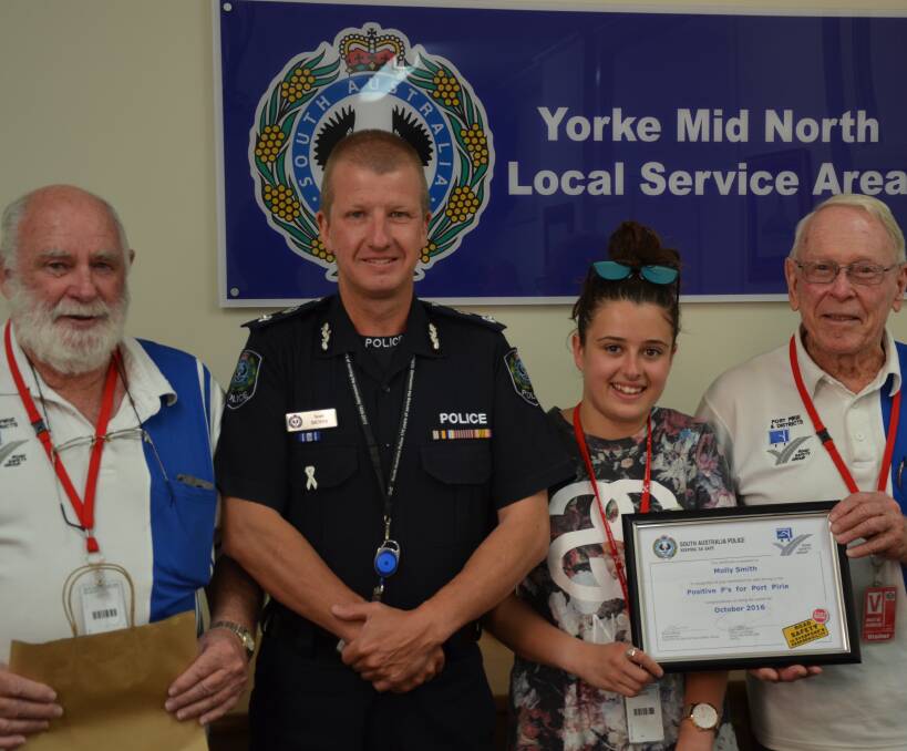 ROAD SAFETY: Port Pirie and Districts Road Safety Group vice president Rex Lang, left, and Bruce James, far right, with Superintendent Scott Denny and Positive P's October winner Molly Smith.