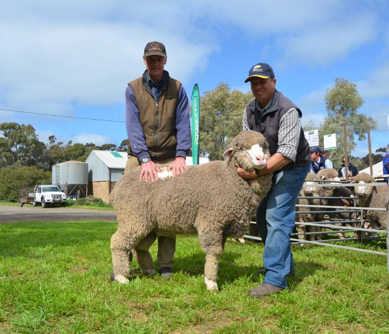 RIPPER RAM: Pindari client for more than 30 years Andrew Baxter, Manoora, bought the $2700 Poll Merino top price ram and stud principal Robin Schwartz. 