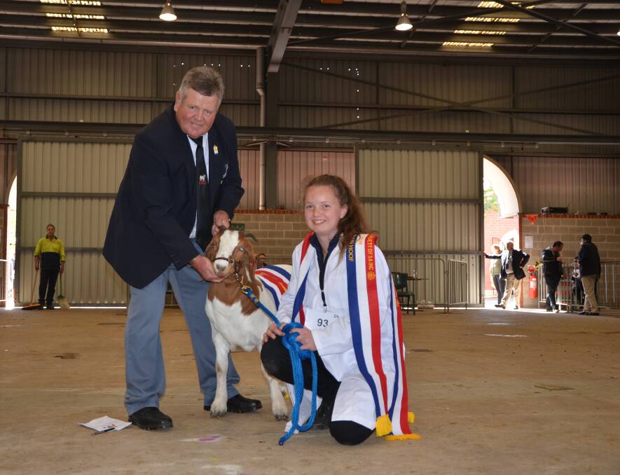 
GRAND GOAT: South African judge Braam Martz, with the grand champion led goat exhibited by Mount Barker High School, and led by Shaeley Shillabeer, 14. 
