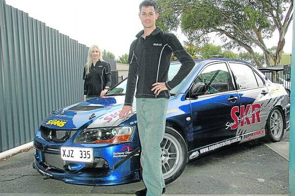 FULL THROTTLE: Tristan Catford and his girlfriend and co-driver Kate Lehmann with the Mitsubishi Lancer Evo 9.