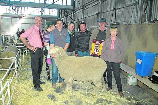 DUELL DELIGHT: Elders stud stock’s Tom Penna with Natalia, Sonia and Brett Koehler, Landmark’s Kevin Keller, and buyers of the $3600 top-price ram Roger, Len and Gail Duell, Bowhill.