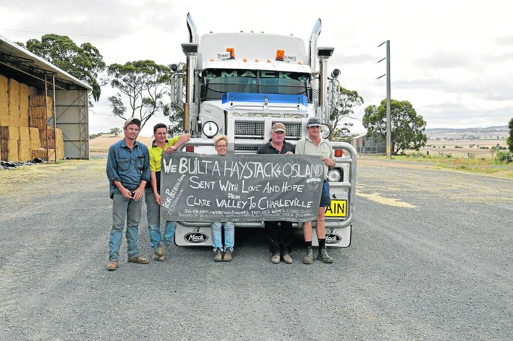 Helping out drought-stricken farmers in Qld are truck driver Max McBride, McBride Transport, Burra, hay donor John Hogben, Auburn, Judy Searley and hay donors Rob Diekman and Peter Marshall, JT Johnson & Sons, Kapunda.  Not pictured is another hay donor - Phillip Allen, Auburn. Photo courtesy of the Northern Argus.