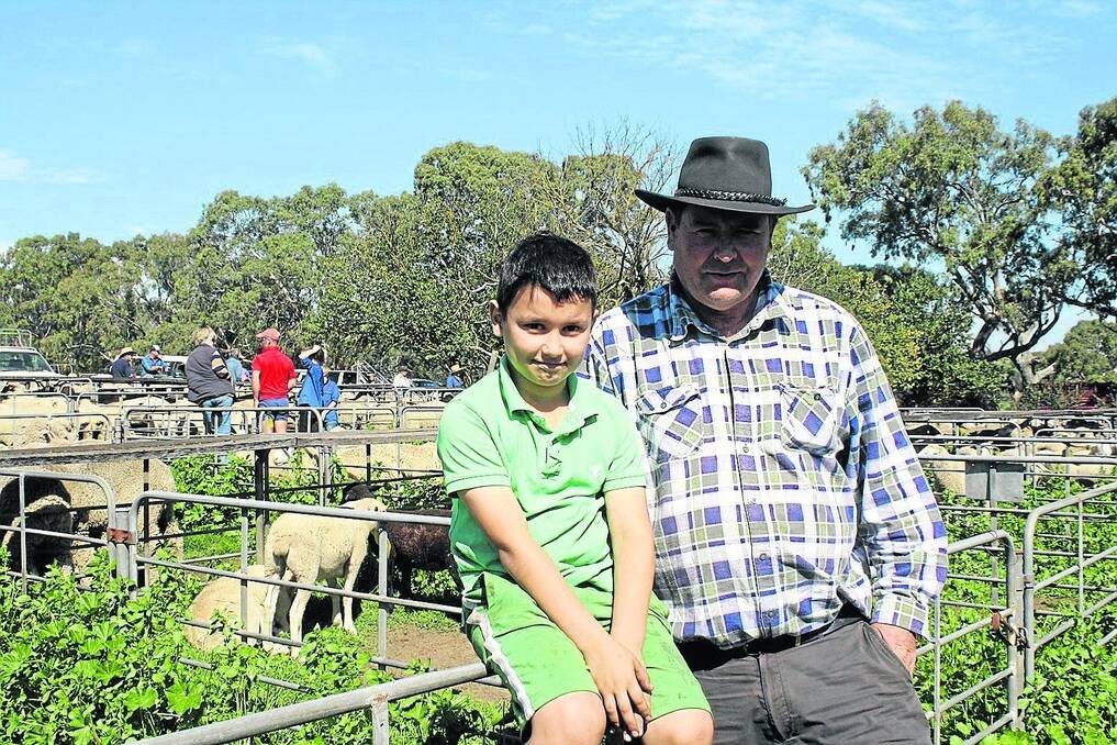 GOOD DAY: Emilio Palma, Balhannah, and his nephew Daniel, 8, were looking for sheep or cattle at last week’s Mount Pleasant market. Mr Palma ended up with two Murray Grey heifers at $450 each which he was pleased with. He said lambs were dearer than he expected, and hard to get hold of.