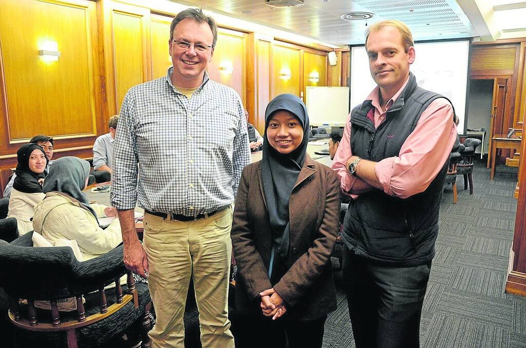 INTERNATIONAL MEETING: University of Adelaide Associate Prof Wayne Pitchford, with Bogor Agricultural University’s Ria Putri Rahmadani, Indonesia, and Elders sales manager David Reed, in the boardroom at Elders House with students from Indonesia.