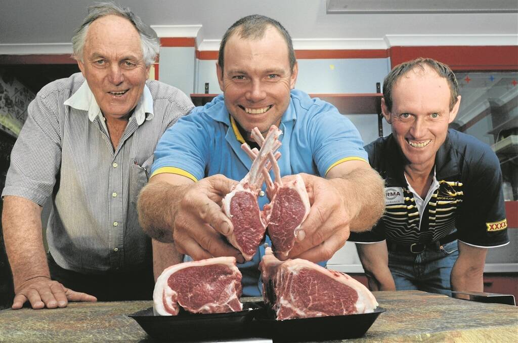 TOP PRICE: The 2013 Wellington Springfest Prime Lamb hoof and hook contest organiser Tom Green with butcher Rodney Dowton, who displays the rib and loin eye muscles of the top-priced lamb, a Charollais/Dohne-cross bred by Matthew Dodds (right), Catombal, Yeoval, NSW.