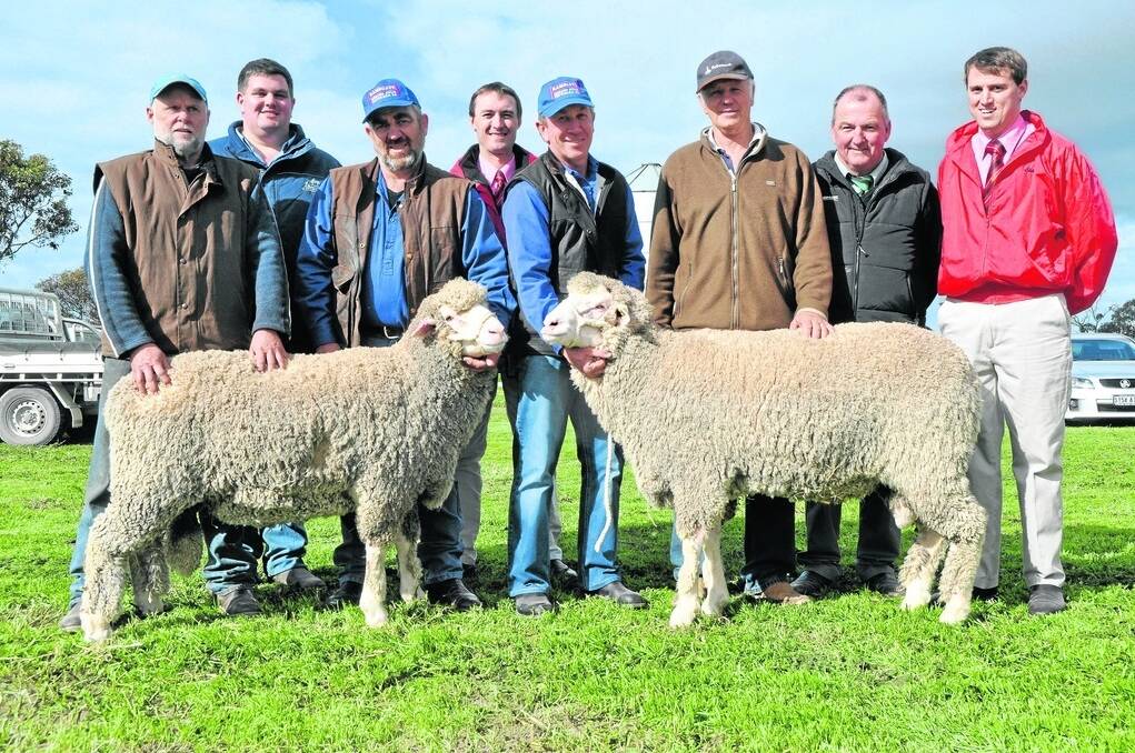 DOUBLE TOP: Two rams made the $1900 equal top price selling to Dean Pearson, Lakeview, Brinkley (left) and Rod Marsson, Coonalpyn (third from right). They are being held by Ramsgate stud principals Jed and Craig Keller with Dean’s agent David Whittenbury, Pro Stock Mount Compass, Elders Keith branch manager Steven Doecke, Landmark Tintinara’s Brenton Jones and Elders Tintinara’s Justin Robertson.