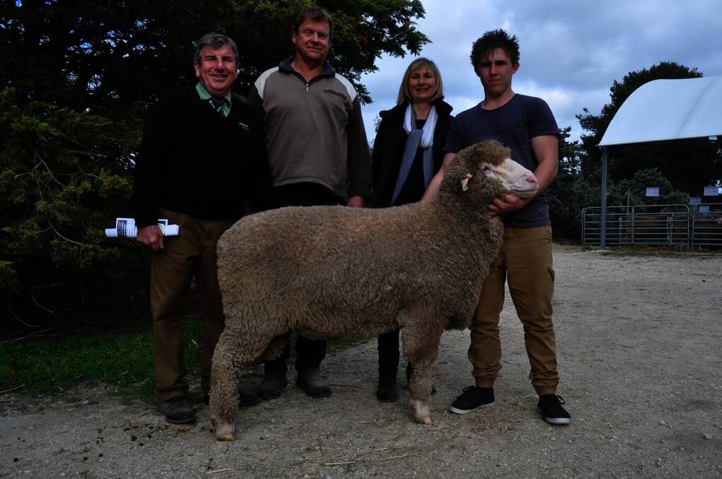 $5400 SIRE: Devon Ridgway holds the stud’s second-highest price ram which sold for $5400 to Glen Farr, Loxton. Also pictured is Landmark auctioneer Malcolm Scroop and Karen Ridgway.
