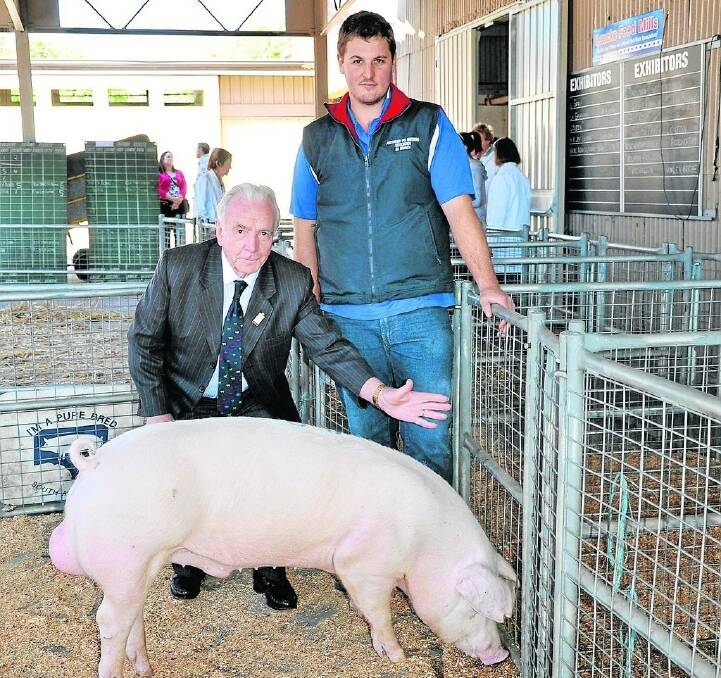 TOP GONG: Judge Robert Overend, Northern Ireland, with Shaun Blenkiron, Gumshire, Keyneton and his family’s best of breed Landrace boar.