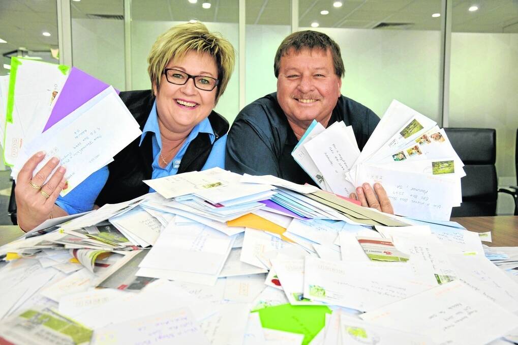 Cheryl and Phil Miegel with some of the many entries received in the 'Win a farmer's trailer' competition.