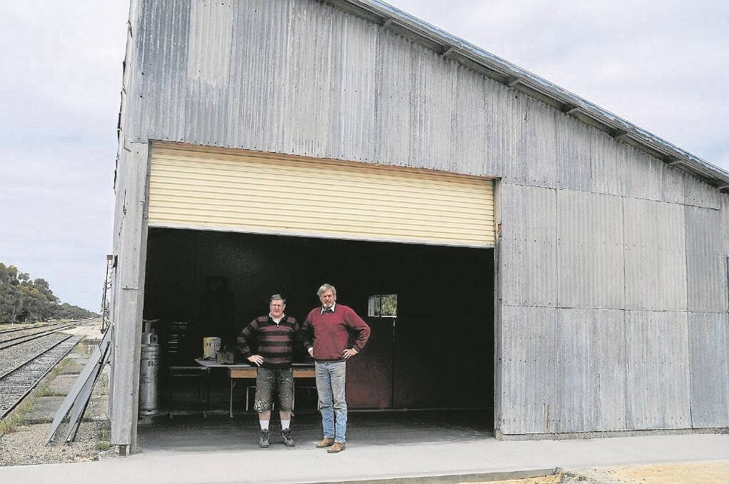 WELCOME SPACE: Tintinara Men's Shed committee member John Beynon and vice president Jim Fairbairn in front of the former railway goods shed which has found a new life as the community's men's shed.