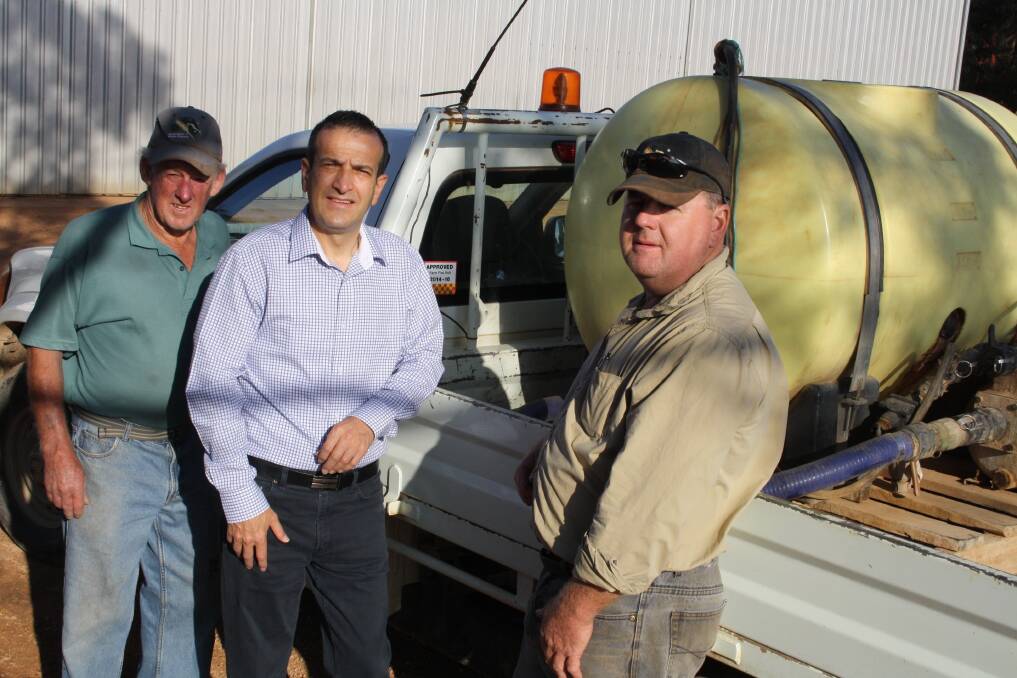 Emergency services minister Tony Piccolo (centre) earlier this month with Mallala farmers Neil and Don Tiller.