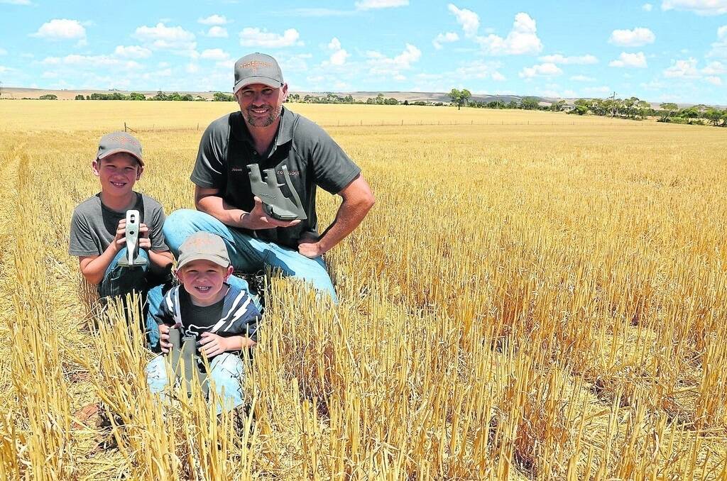 POSITIVE RESULTS: Out in the paddock with his sons Wil, 8 and Eli, 2, is Eudunda farmer and creator of the Rootboot system Jason Pfitzner. Inset: A close up of Rootboot, which received glowing reviews from farmers across Australia.