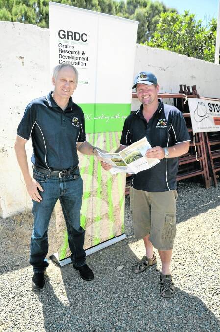 READY ADVICE: Rural Solutions farming systems consultant Michael Wurst with Upper North Farming Systems trial manager Matt McCallum and the recently-launched book of guidelines for inter-row sowing.