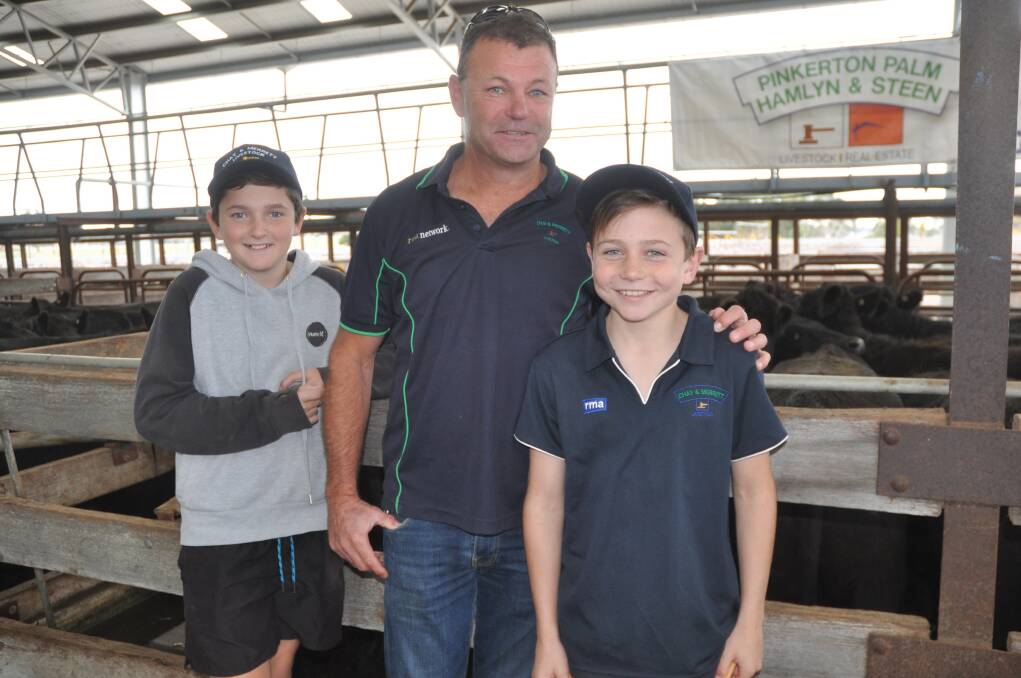 FAMILY TIME: School holidays were a chance for Will and Paddy Chay to accompany their father John Chay, Chay & Merrett, Millicent, to the Naracoorte store sale. One of John's clients, PJ&MW Bellinger, sold the top pen of steers at $1050.