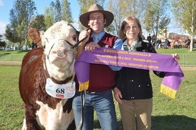 Lachy Day, Days Whiteface stud, Bordertown receives the most successful Poll Hereford exhibitor ribbon from Landmark Albury's Julie Gittoes.