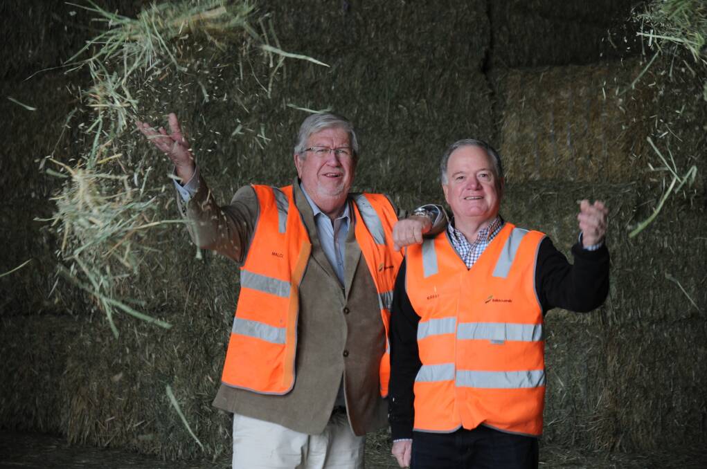 Balco Australia co-founding directors Malcolm May and Murray Smith celebrate the company's joint venture with Chinese feed importer Shanghai Yanhua Hi-Tech.