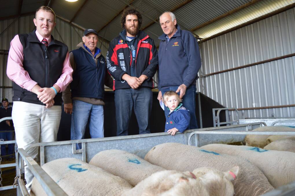 Dean Coddington, Elders Keith, with Tongara principal Leigh Richards, Netherton, and top price buyers Brian, Lyndon and Caleb Hampel, Loxton, in front of their two new rams. 