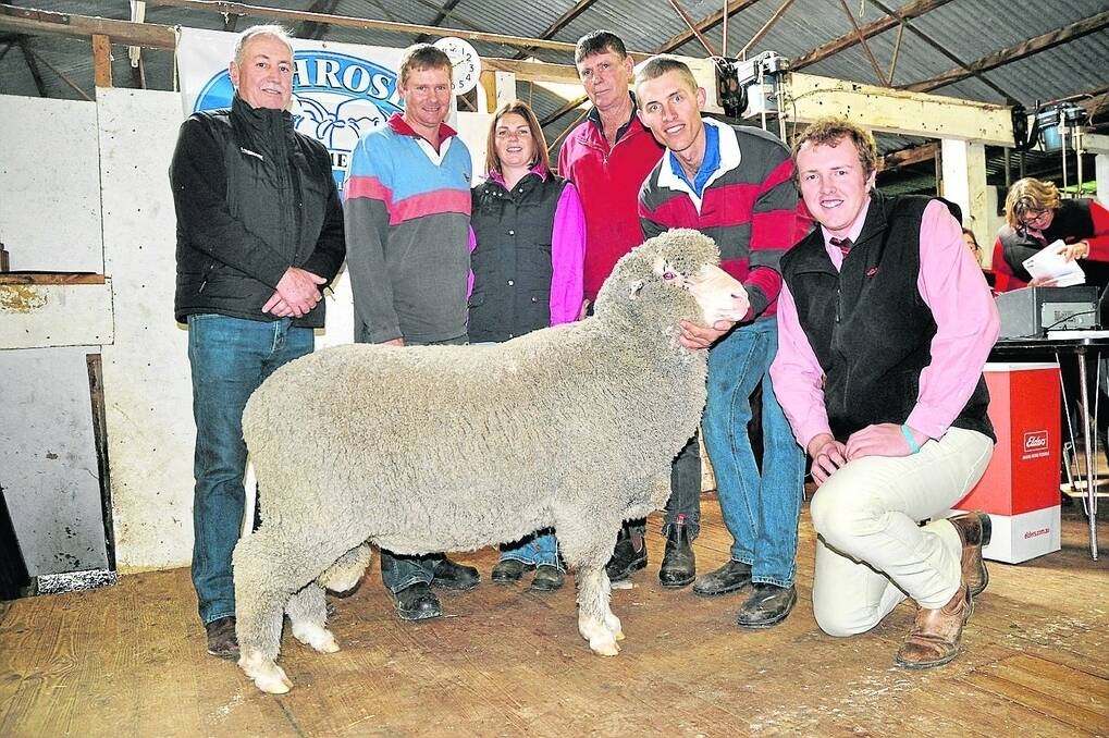 Tim Graetz, Ashrose stud, Mundulla, holds the $2800 top-price ram bought by Shane, Laura and Terry Rivett, Avenue Range.They are with Landmark Kingston branch manager Trevor Wiseman (left) and Elders Keith territory sales manager Dean Coddington (kneeling).
