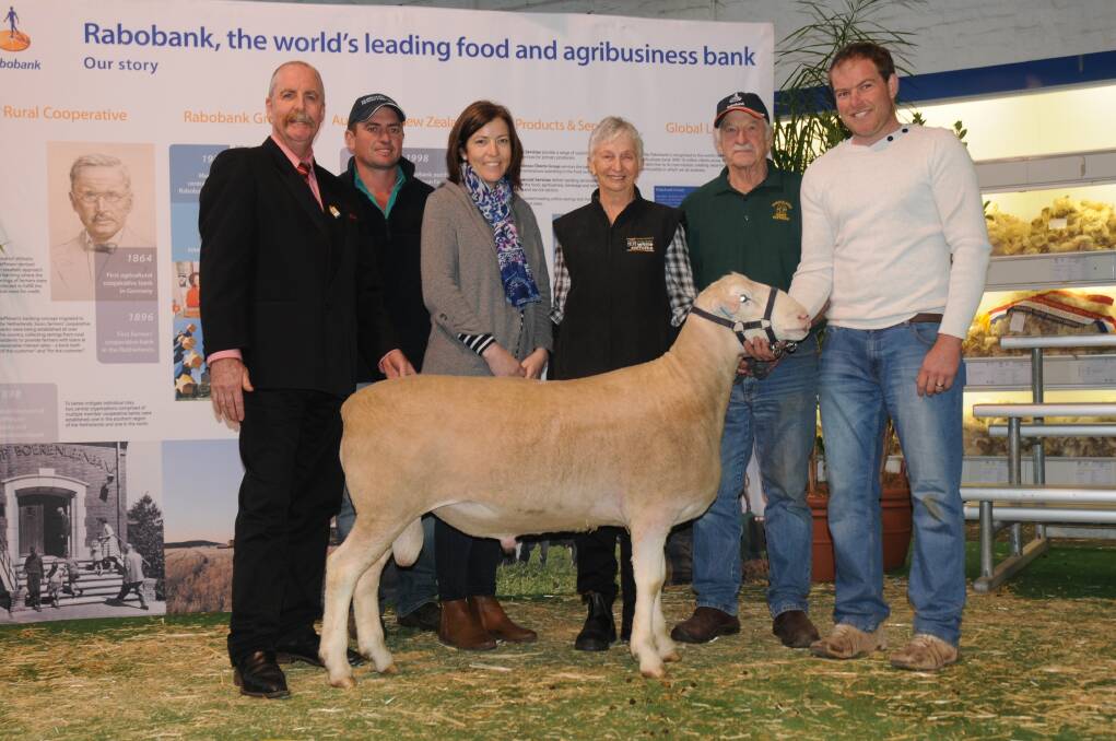 Elders auctioneer Tom Penna, Ben and Lucy Prentice, Kurralea White Suffolks, Ariah Park, NSW, vendors Idrienne and Bob Neill, Wheetelande White Suffolks, Farrell Flat, and Leroy Hull, Kattata Well White Suffolks, Port Kenny, with the $22,000 top-price ram.