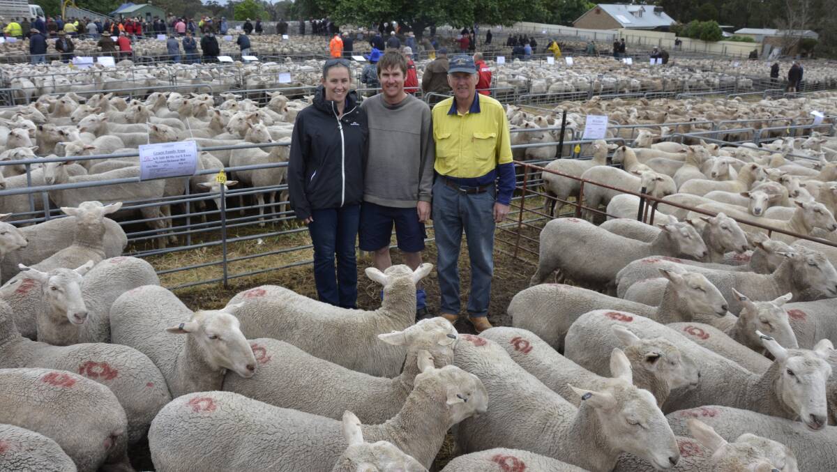 Emma Brock with her fiancee Kym Graetz and his dad James Graetz, all of Keyneton, and their $338 sale-topping first-cross ewes.