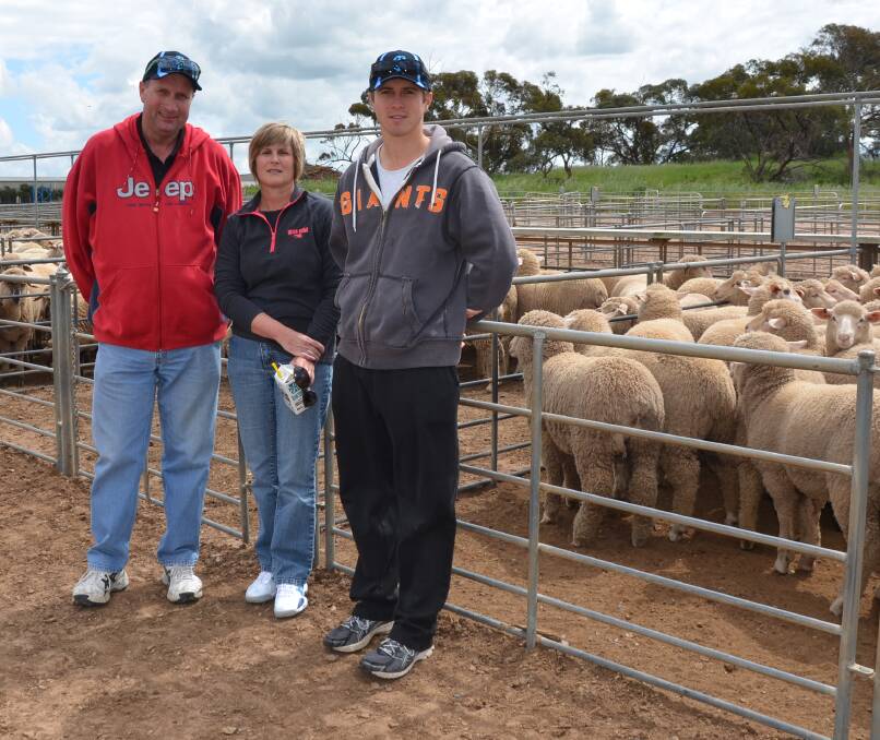 FAMILY EVENT: Neale and Gill Biddle, with son Chris, Meningie, checked out the Murray Bridge market, where crossbred lambs made to $125.