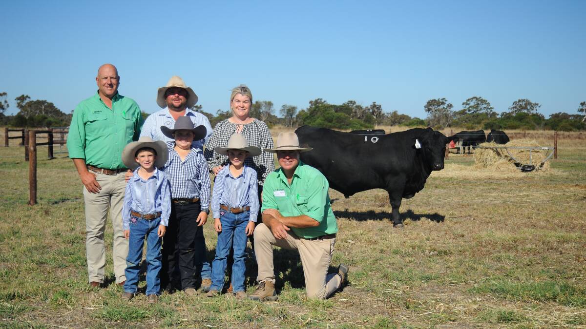 Stud principals Heath and Jenna Tiller with children Clarry, Henry and Eddy, and Nutrien's Anthony Driessen and Richard Miller with sale topper Goolagong Stellar T67. Pictures by Katie Jackson