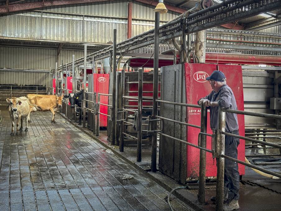 Garry Carpenter stands in the dairy at his Gunns Plains farm where there are seven robotic milkers. Picture supplied