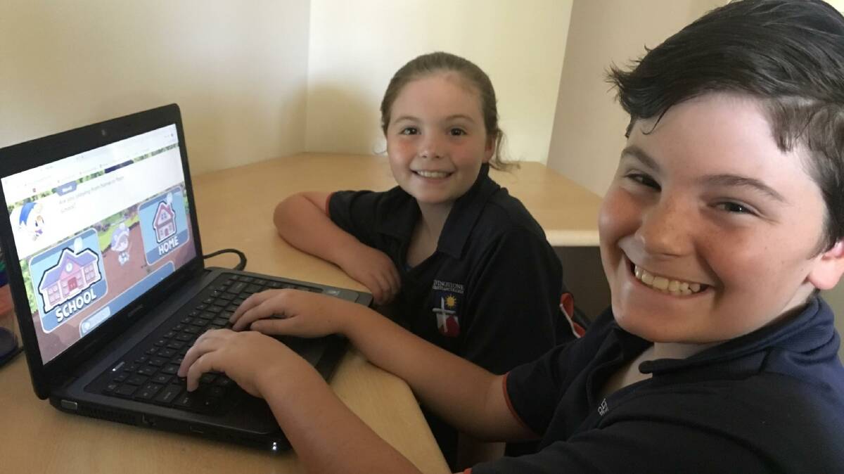 CONNECTED LEARNING: Primary school students Grace and Henry Ball utilise a mobile data connection to access an online school tutorial website. 