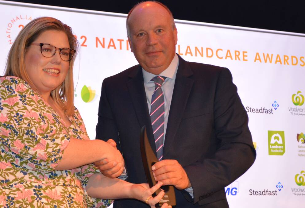 The winner of Landcare Australia's highest gong, Bruce Maynard, Narromine, NSW, collects the 2022 Bob Hawke Award from Department of Agriculture, Water and the Environment director, Karen Walsh, at the Sydney national conference.
